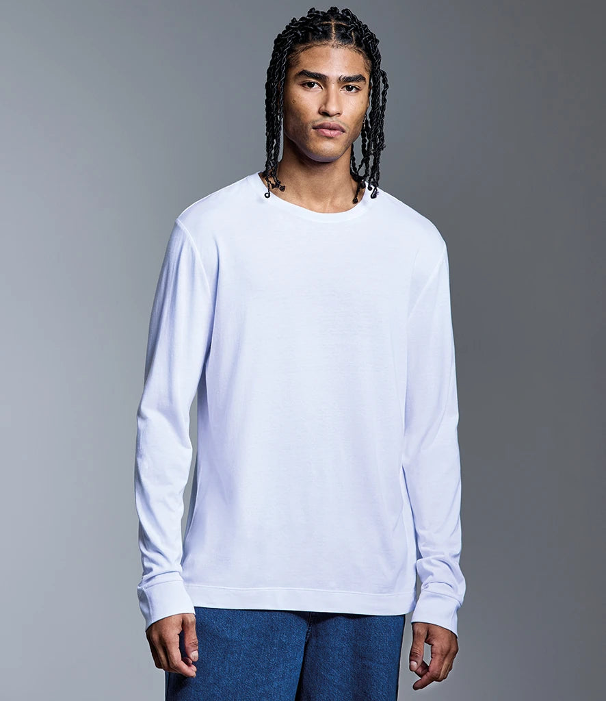 Person wearing a white long-sleeve shirt against a gray background
