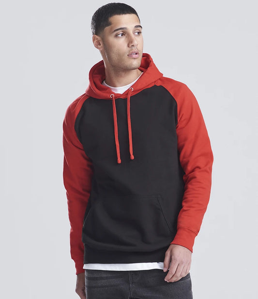Man wearing a black and red hoodie on a gray background