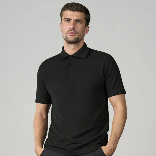 Man wearing a black polo shirt against a gray background