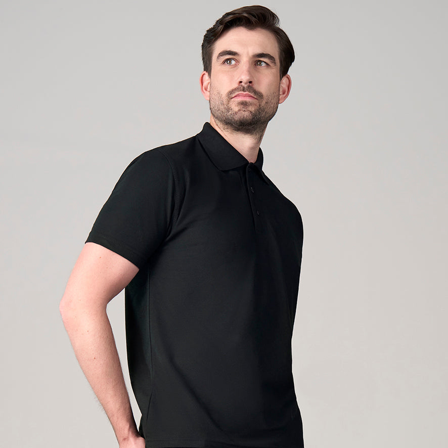 Man wearing a black polo shirt against a gray background