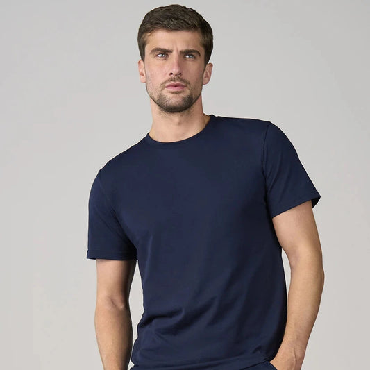 Man wearing a navy blue t-shirt against a gray background